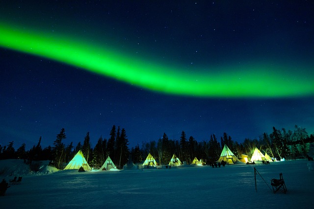 Aurora borealis green lights over a frozen lake in Yellowknife Canada